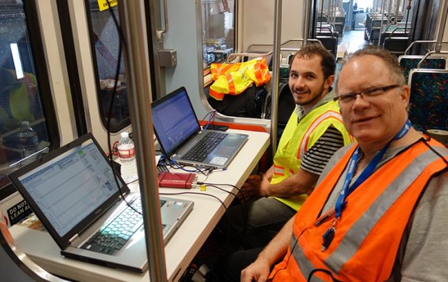 Two men working in railcar